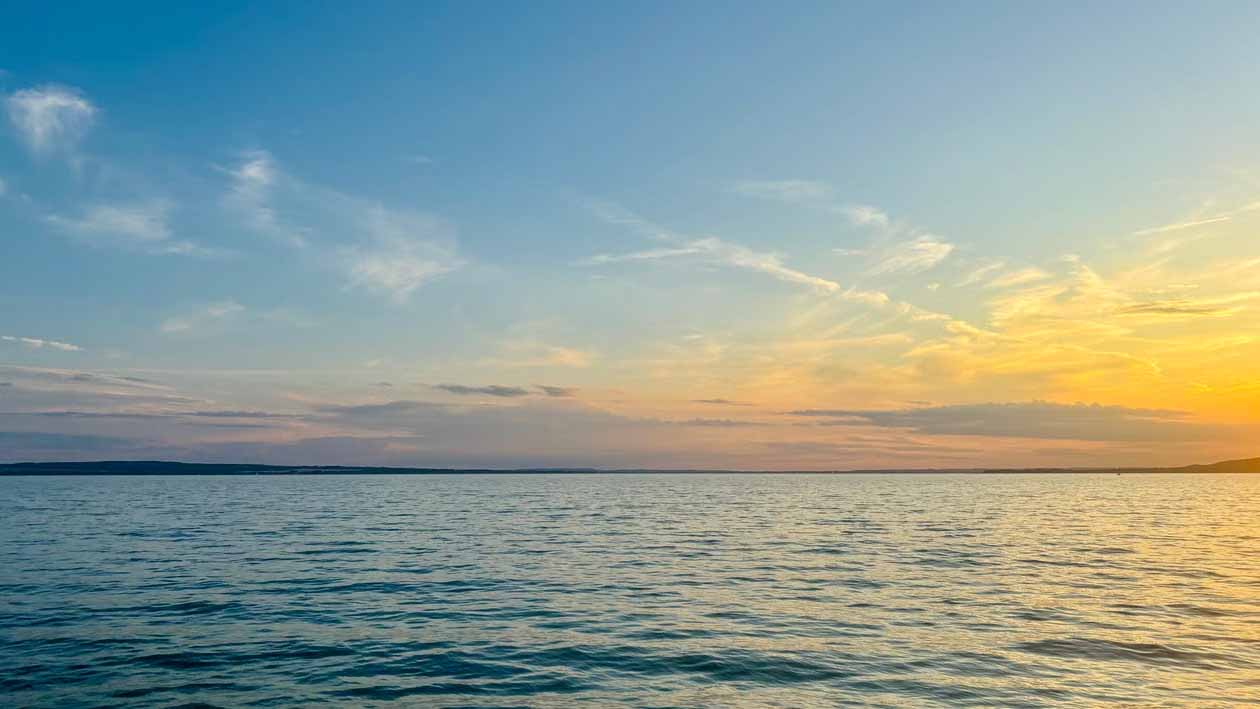Calm harbour water at sunset ahead of a dry Auckland spring